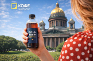 Cold brew кофе в Санкт-Петербурге — летний тренд 2026 года Девушка с бутылкой cold brew на фоне Исаакиевского собора в Санкт-Петербурге